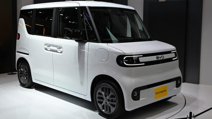 White BYD RACCO kei electric car prototype on a display stand in Japan (cropped)