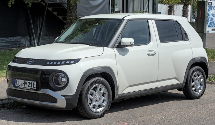 A white Hyundai Inster compact electric SUV parked outdoors