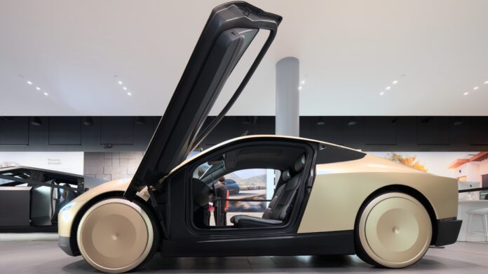 Gold Tesla Cybercab seen from the side with its butterfly door raised, on display at Santana Row in San Jose