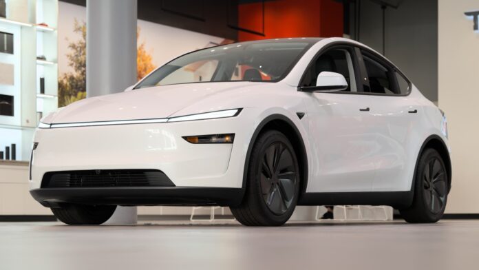 White 2025 Tesla Model Y on display inside a Tesla showroom at Santana Row, San Jose (cropped)