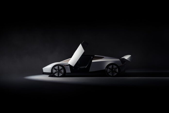 Side profile of the new 2026 Tesla Roadster in white with its butterfly door open, against a dark studio background