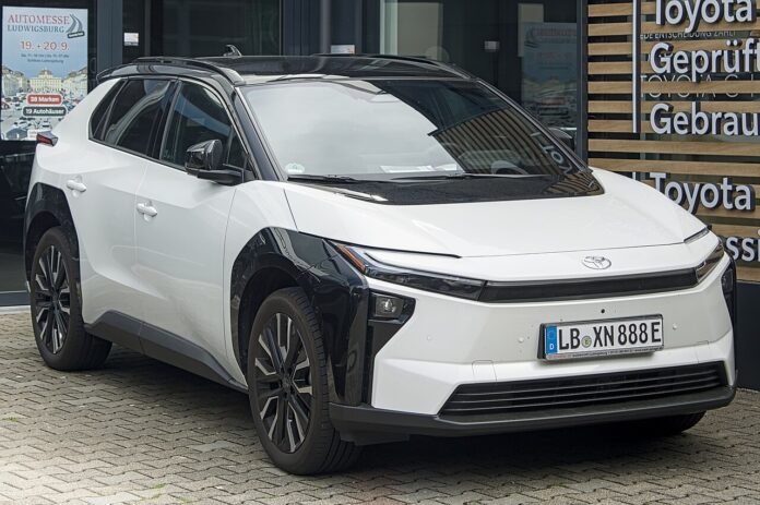 White 2026 Toyota bZ4X electric SUV parked outside a dealership