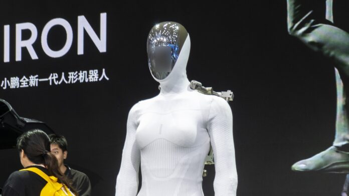 Xpeng Iron humanoid robot standing on display at Auto Guangzhou 2025